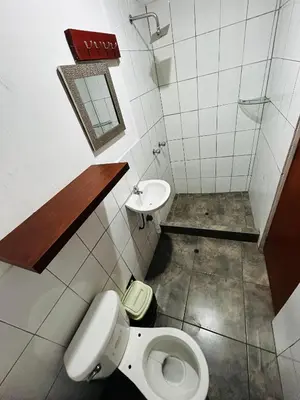 a bathroom with a toilet and a sink at Hotel World Peru in Lima