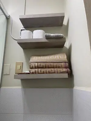 a bunch of towels are sitting on shelves in a bathroom at Mini Apartment Ares 2 in Lima