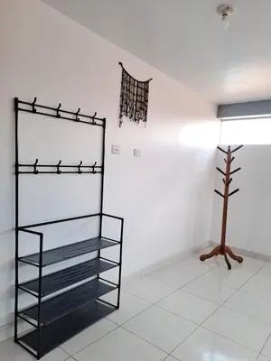 a room with a black shelf and a tree at Nina's House in Cusco