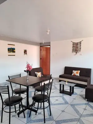 a living room with a table and chairs and a couch at Nina's House in Cusco