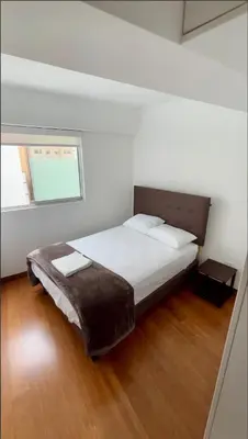 a bedroom with a large bed with a window at Luxloft in Lima