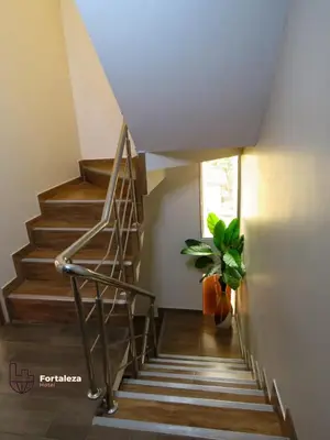 a staircase in a house with a potted plant at Hotel Fortaleza in Chasquitambo