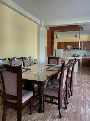 a dining room with a wooden table and chairs at Habitación triple in Huayllabamba