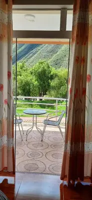 a view of a patio with a table and a table at Habitación triple in Huayllabamba