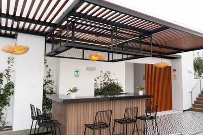 a patio with chairs and a bar in a building at Patria Inca Inn in Lima