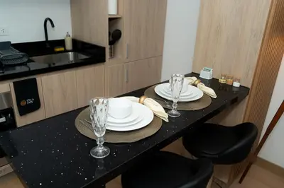 a table with plates and glasses on it in a kitchen at Patria Inca Inn in Lima