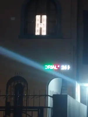 a neon sign on the side of a building at Hospedaje el señorial in Lima