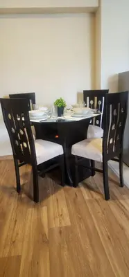 a black dining room table with two chairs and a table and chairsuggest at Depa UMBRA, one block from Rebagliati Hospital in Lima