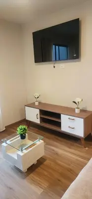 a living room with a flat screen tv on the wall at Depa UMBRA, one block from Rebagliati Hospital in Lima