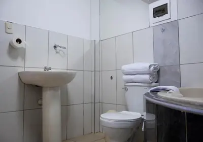 a bathroom with a white toilet and a sink at Los Chullos in Cusco