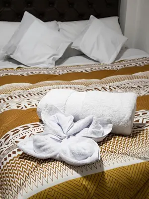 a towel on a bed with a towelvisorvisor at Los Chullos in Cusco