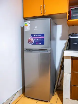 a stainless steel refrigerator in the corner of a kitchen at Los Chullos in Cusco