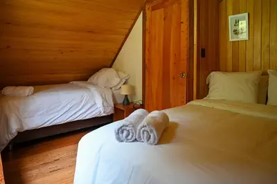 a bedroom with two beds with towels on them at Montecatini Ecolodge in Oxapampa