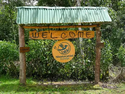 a sign for a welcome to a welcome sign at Montecatini Ecolodge in Oxapampa