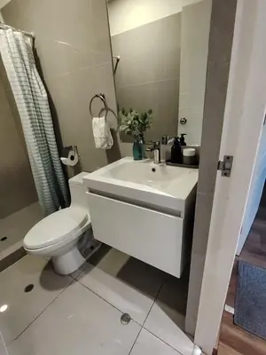 a bathroom with a white sink and a toilet at GOLD DÚPLEX único c PISCINA PRIVADA MIRAFLORES P República 5655 in Lima
