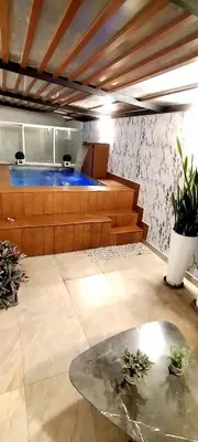 a living room with a table and some plants at GOLD DÚPLEX único c PISCINA PRIVADA MIRAFLORES P República 5655 in Lima