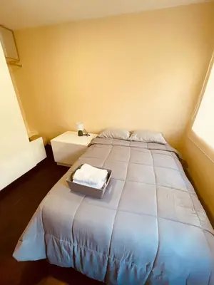 a bedroom with a large bed with a tray on it at Céntrico Dpto Puca Lima a 2 cuadras de Hospital Rebagliati y Real Plaza Salaverry in Lima