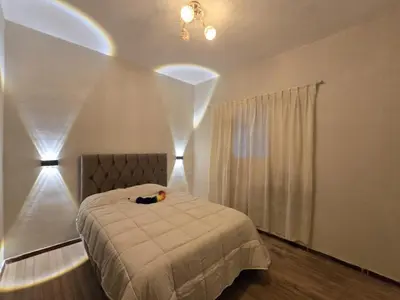 a bedroom with a bed and a window with curtains at Mica&Tory in Cusco