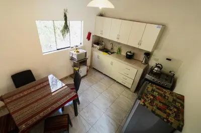 an overhead view of a kitchen with a table at Pinkuylluna Lodge in Ollantaytambo