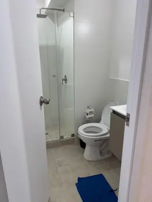 a bathroom with a toilet and a glass shower at 2-Bedroom Apt, Perfect for Family or Work Stays in Lima