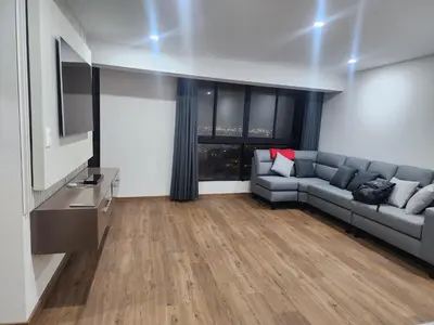 a living room with a couch and a television at 2-Bedroom Apt, Perfect for Family or Work Stays in Lima