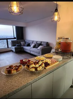 a kitchen with several plates of food on a counter at 2-Bedroom Apt, Perfect for Family or Work Stays in Lima