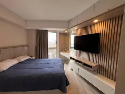 a bedroom with a bed and a flat screen tv at Departamento Salaverry in Lima