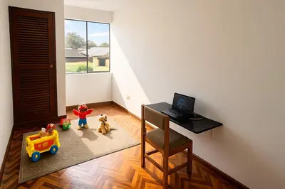 a room with a desk with a laptop and toys at Lima Family Lodge Apartment near Miraflores Center in Lima