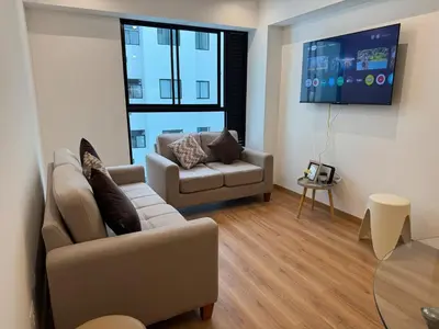 a living room with a couch and a table at TyB apartment in Lima