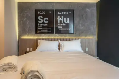 a bedroom with a bed with two posters on the wall at Solar Breezy Retreat by Geko in Lima
