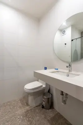a bathroom with a toilet and a sink and a mirror at Solar Breezy Retreat by Geko in Lima