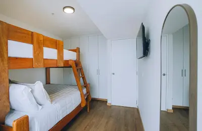 a bedroom with two bunk beds and a mirror at Luxurious Apartment in the heart of Miraflores in Lima
