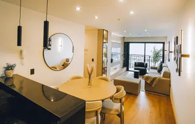 a living room with a table and a mirror at Luxurious Apartment in the heart of Miraflores in Lima