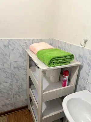 a shelf in a bathroom with a green towel on it at Private Whole Apartment in Surco close to Barranco in Lima