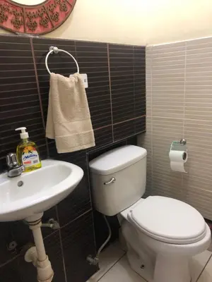 a bathroom with a toilet and a sink at Departamento familiar Lucrepata in Cusco