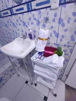 a bathroom with a sink and a towel rack at IN FRONT OF THE NEW AIRPORT Hospedaje - A y C Taxi Free - Airport - Apartment on the 1st Floor in Lima