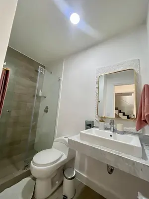 a bathroom with a sink and a toilet and a mirror at LimaeStays Exclusive penthouse in downtown Barranco in Lima