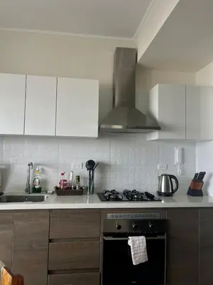 a kitchen with white cabinets and a stove top oven at LimaeStays Exclusive penthouse in downtown Barranco in Lima