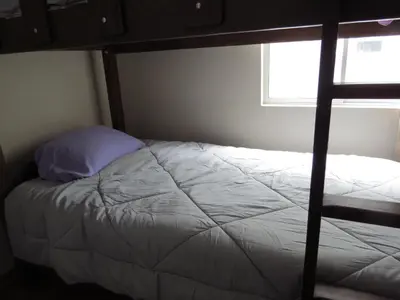 a bed in a bedroom with a bunk bed at Panoramic View in Lima