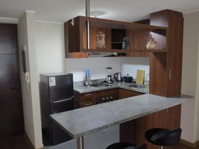 a kitchen with a counter and a black refrigerator at Panoramic View in Lima