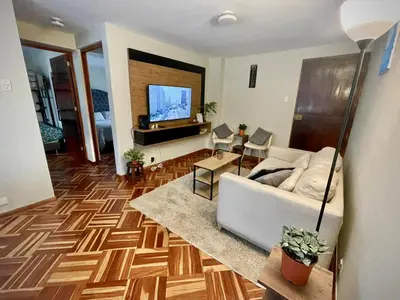 a living room with a couch and a flat screen tv at Close to the beach, Big beds, Malecon Miraflores in Lima