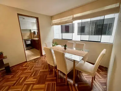 a dining room with a table and white chairs at Close to the beach, Big beds, Malecon Miraflores in Lima