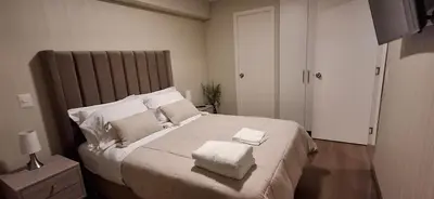 a bedroom with a large white bed with two pillows at Acogedor departamento 1 dormitorio in Lima