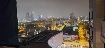 a view of a city at night from a building at Acogedor departamento 1 dormitorio in Lima