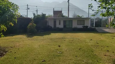 a yard with a house with a hose at La Casita de Condoray - Lunahuana in Lunahuaná