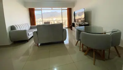 a living room with a glass table and chairs at Apartment in downtown Huancayo in Huancayo