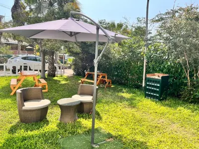 an umbrella and chairs and a table and a table at Casa Rosé Vacacional in Santa Rosa