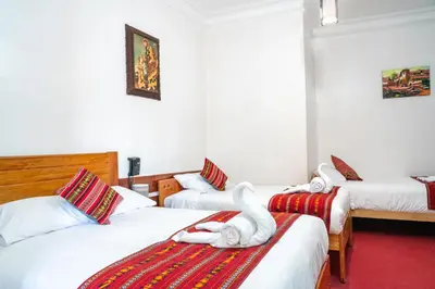a hotel room with two beds with swans on them at HOTEL PALACE DIAZ inn in Cusco