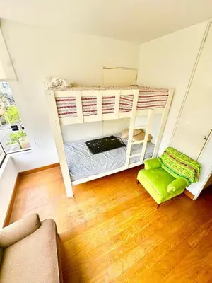 a room with two bunk beds and a couch at Ocean View Nice and cozy in Lima