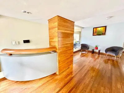 a living room with wood floors and a bar stool at Ocean View Nice and cozy in Lima